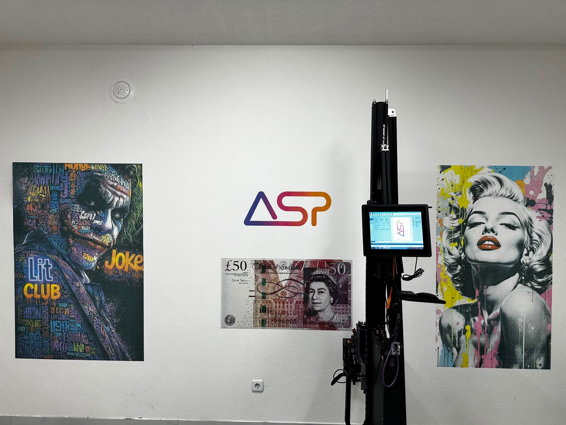 Interior wall with three large printed artworks beside the ASP printing unit.